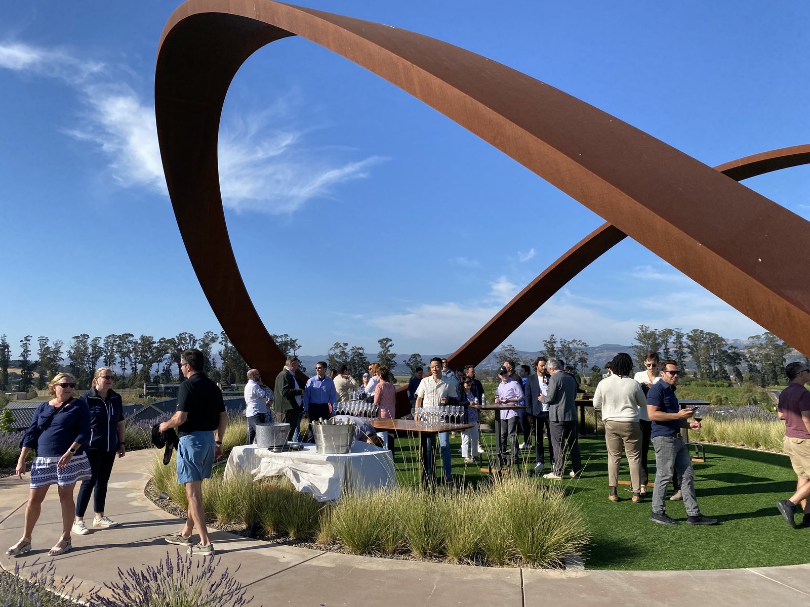 Founders at the welcome wine reception beneath the steel arches