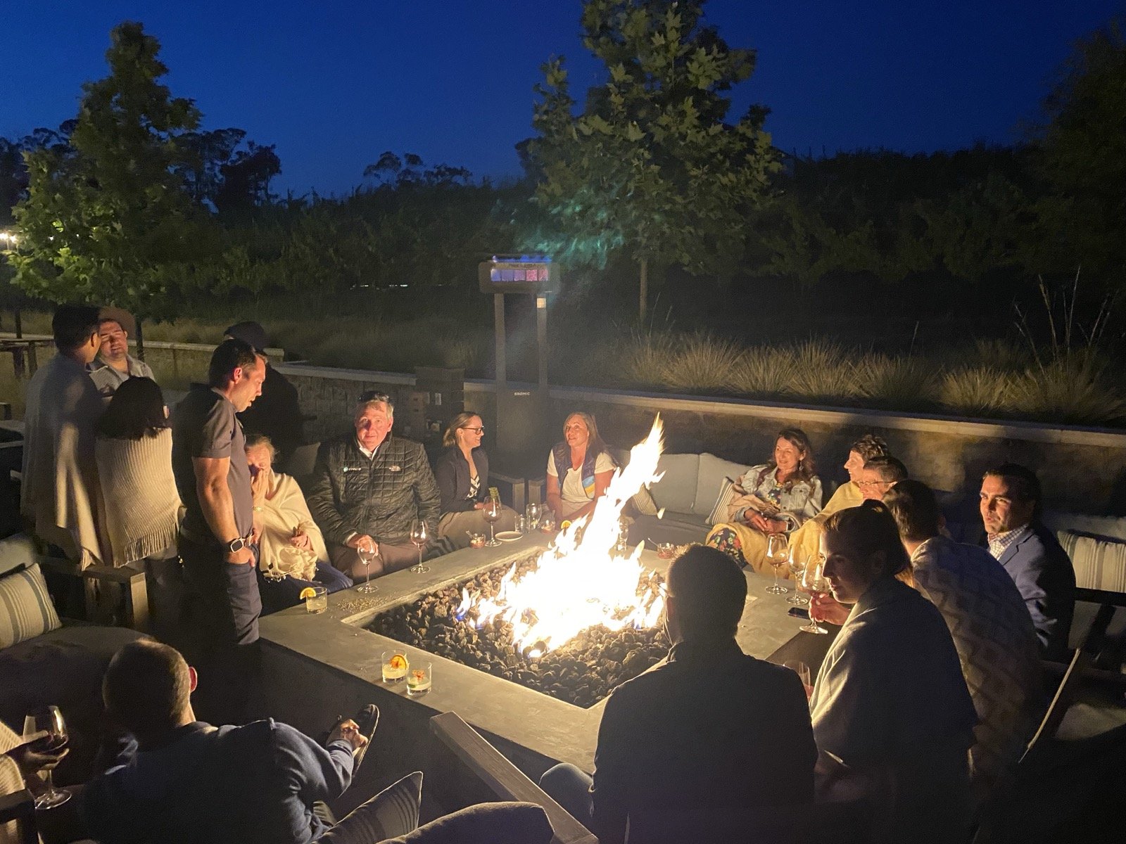 Founders gathered around the firepit at dusk