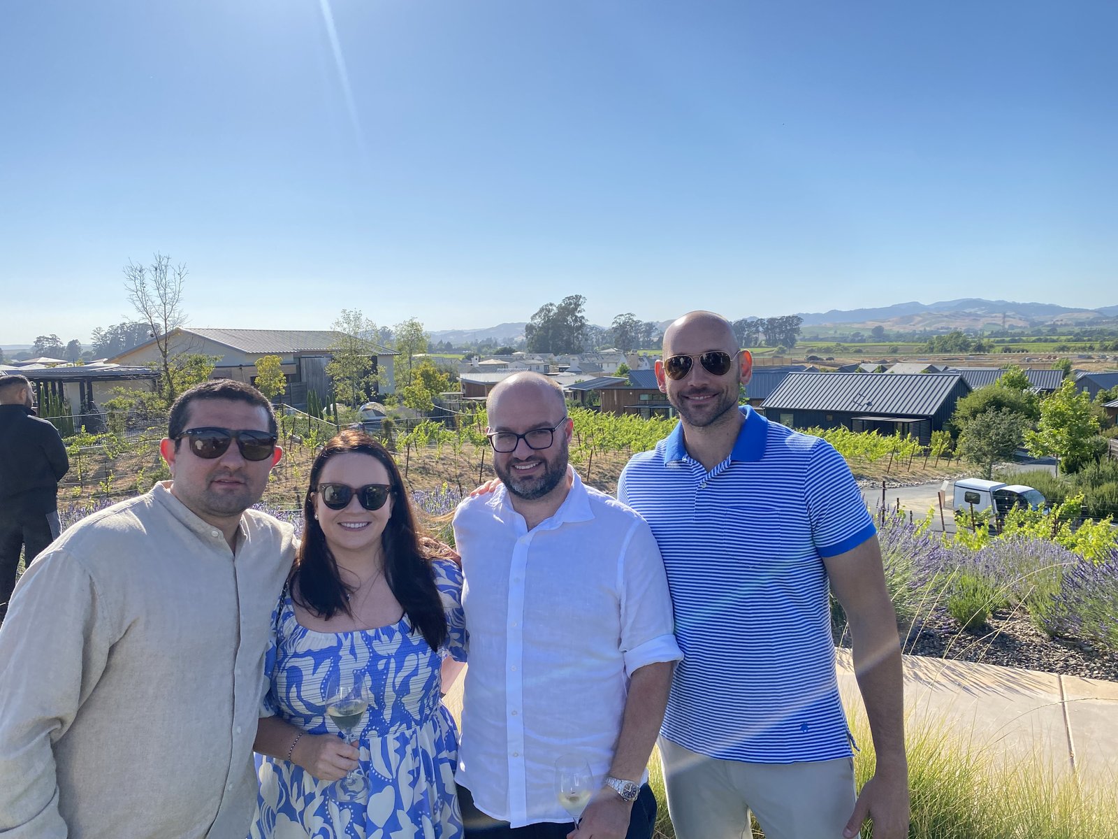 Four founders together overlooking the vineyard